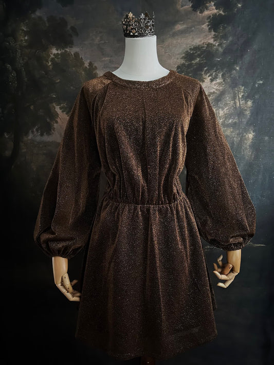 A medieval knight inspired metallic brown / bronze tunic dress with puffy bishop sleeves on a mannequin in front of an art history backdrop