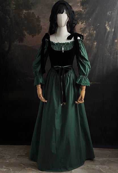 A historical fashion inspired outfit consisting of a forest green chemise a la reine style dress with bell sleeves, a black velvet corset, a green velvet belt, and silver jewelry.
