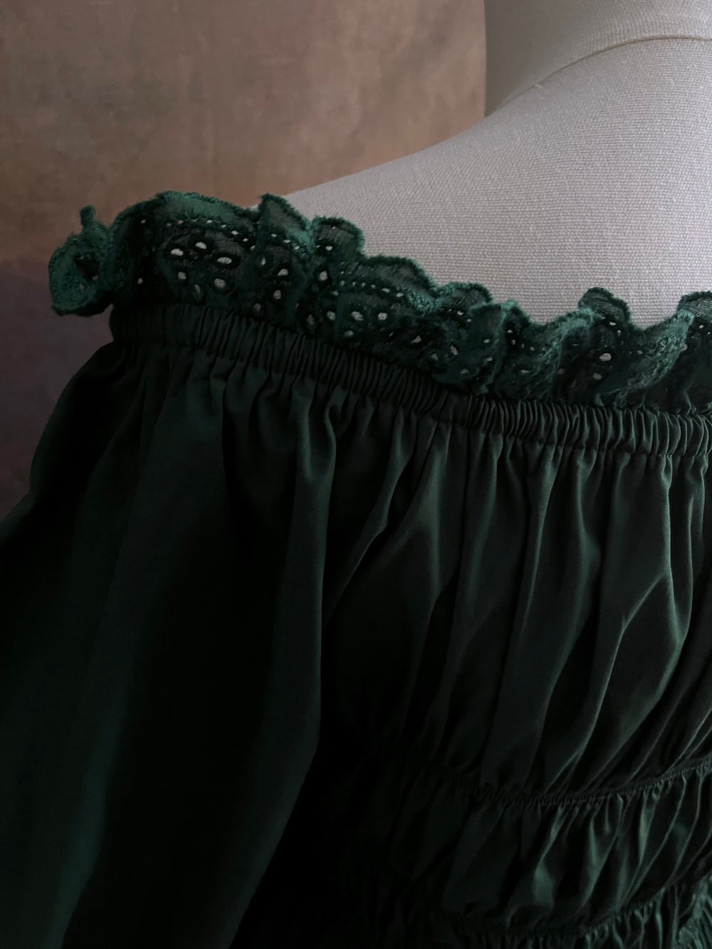 Lace details on a historically inspired green chemise dress