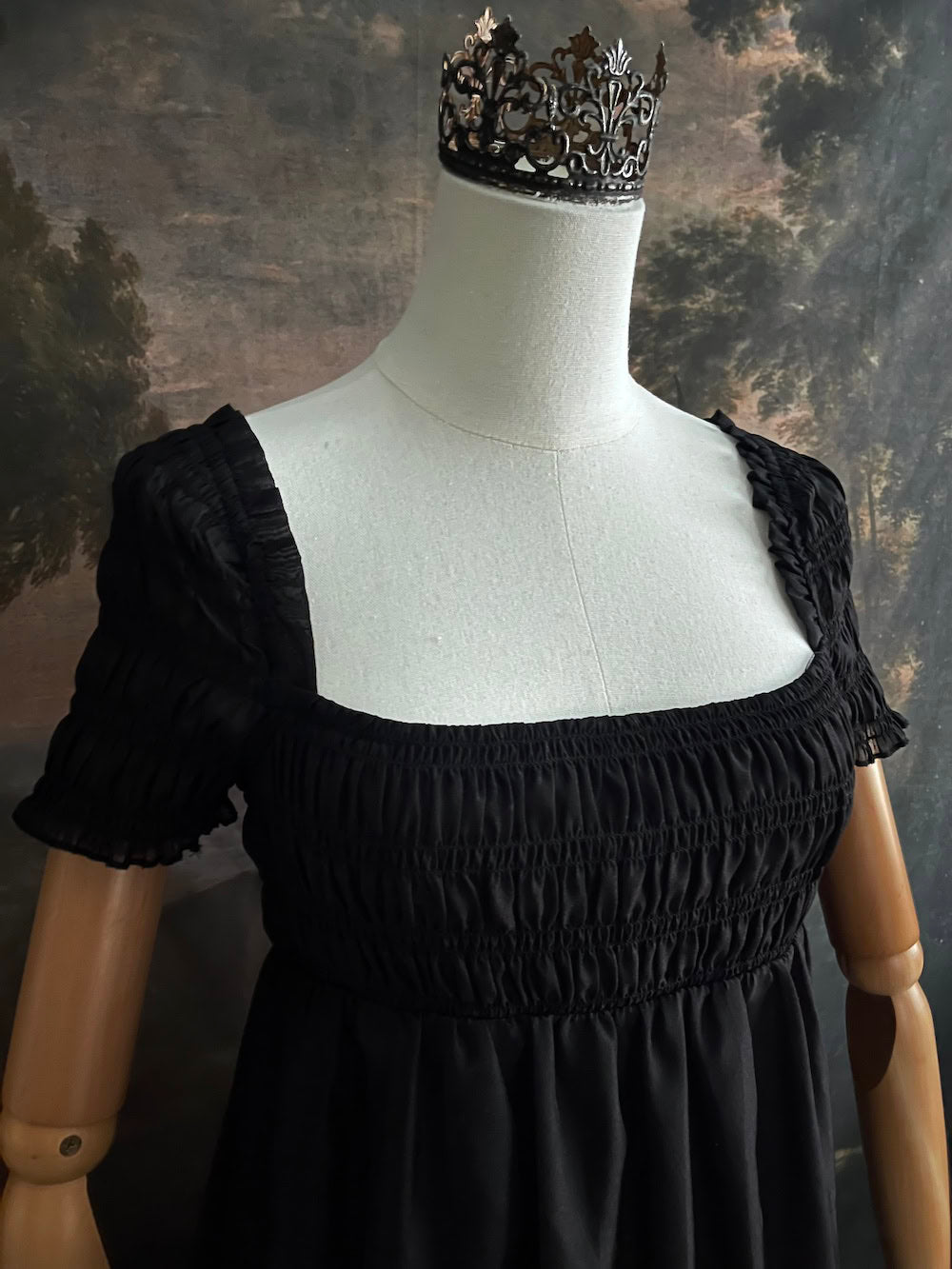 A historical fashion inspired regency era style black tiered empire waist mini dress with shirred square neckline bodice