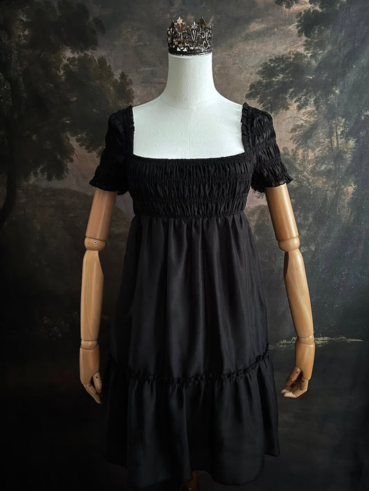 A historical fashion inspired regency era style black tiered empire waist mini dress with shirred square neckline bodice