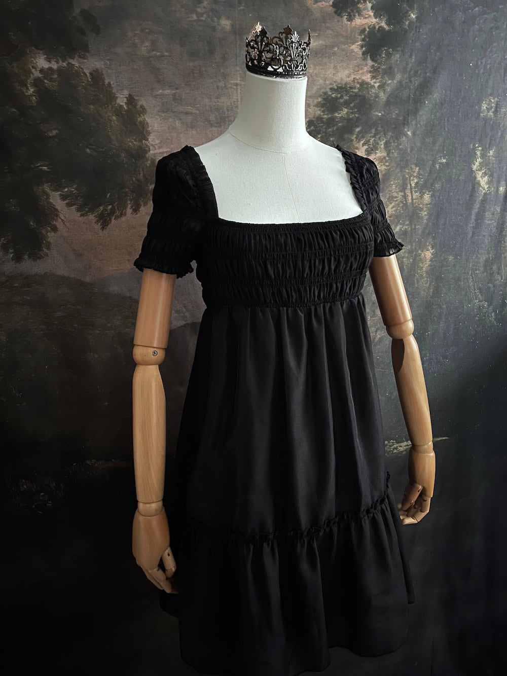 A historical fashion inspired regency era style black tiered empire waist mini dress with shirred square neckline bodice
