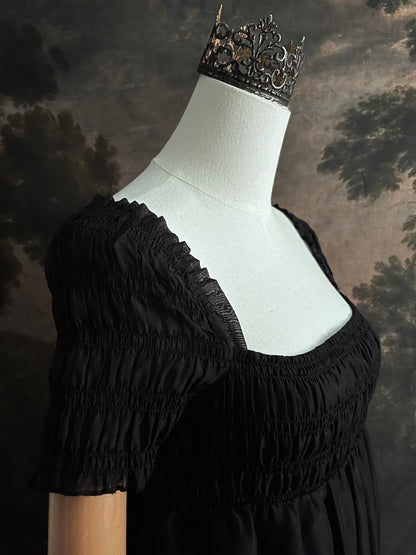 A historical fashion inspired regency era style black tiered empire waist mini dress with shirred square neckline bodice