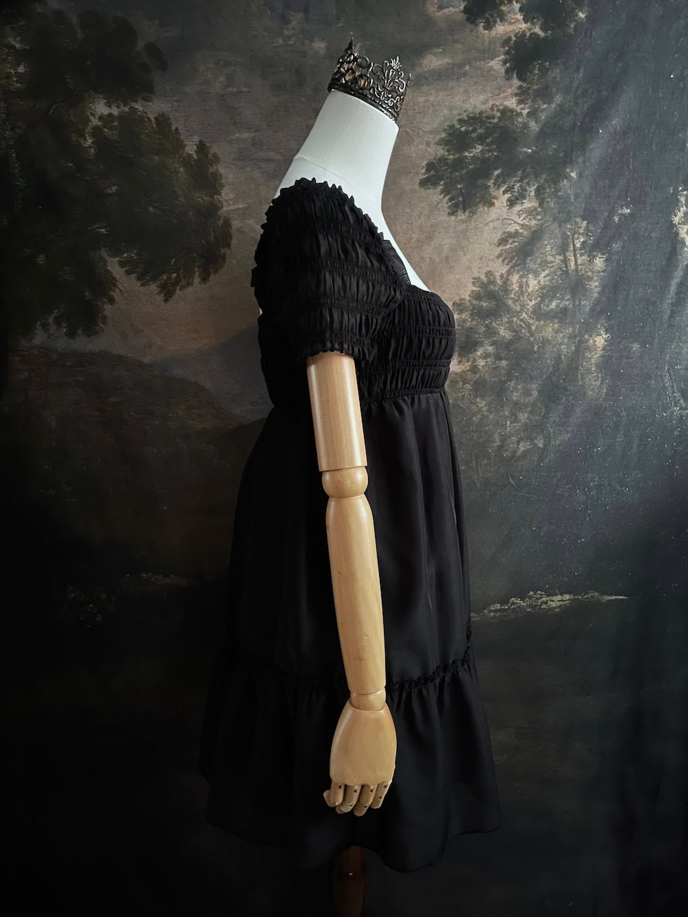 A historical fashion inspired regency era style black tiered empire waist mini dress with shirred square neckline bodice