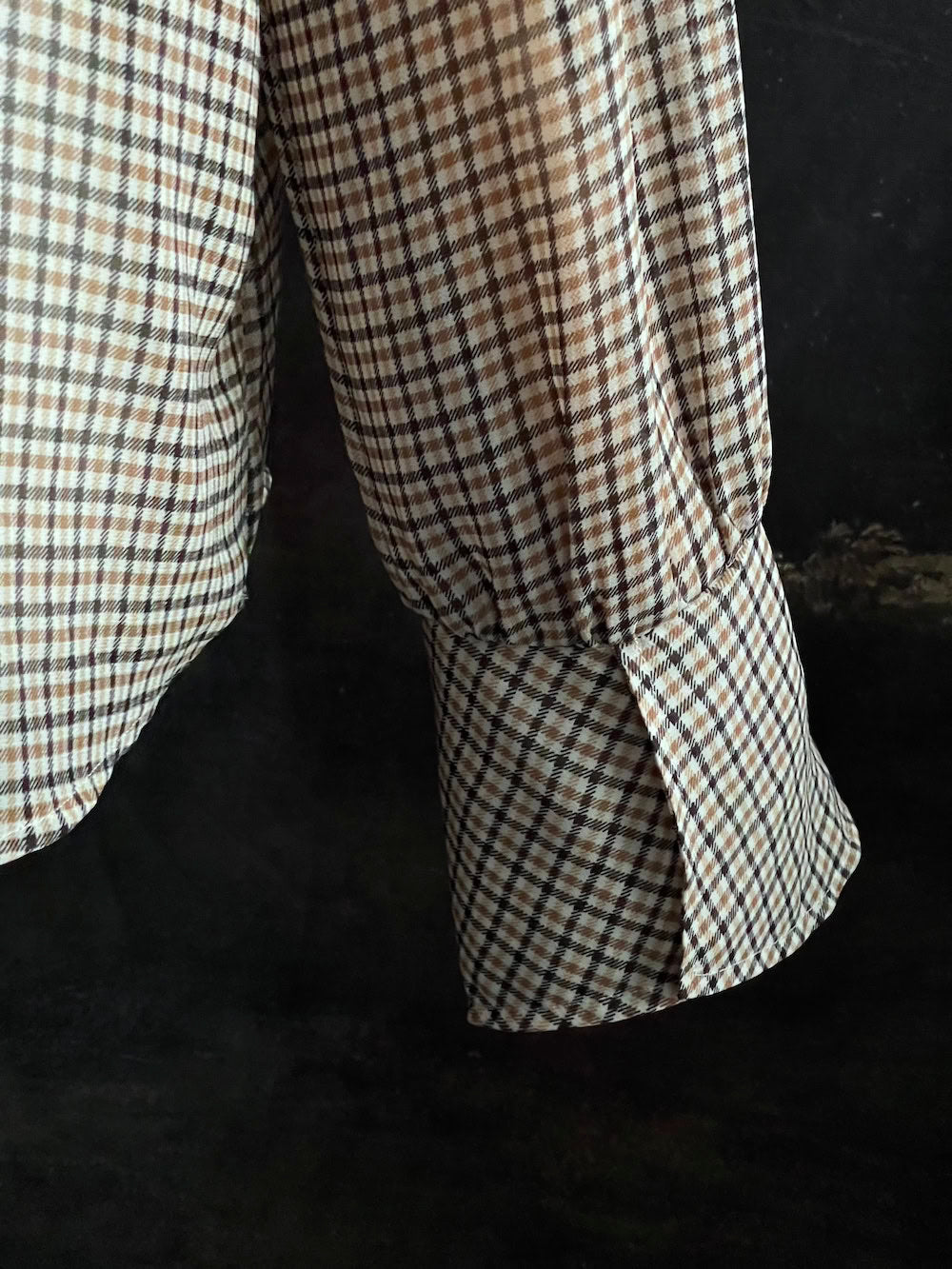 Mannequin wearing a vintage style historically inspired gingham check plaid blouse with bell sleeves and a mock neckline