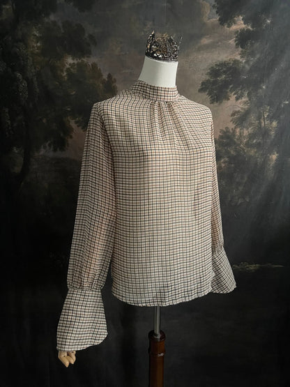 Mannequin wearing a vintage style historically inspired gingham check plaid blouse with bell sleeves and a mock neckline