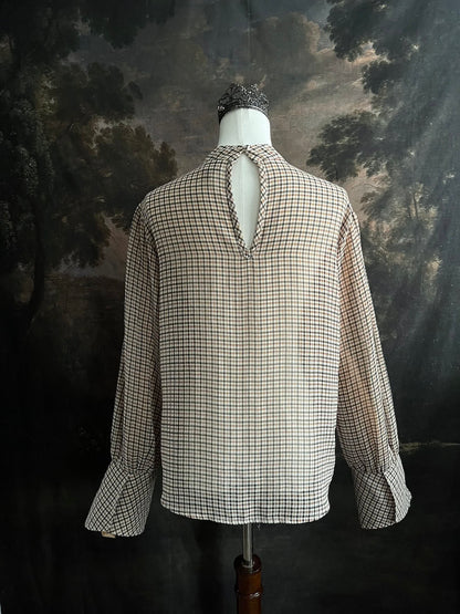 Mannequin wearing a vintage style historically inspired gingham check plaid blouse with bell sleeves and a mock neckline