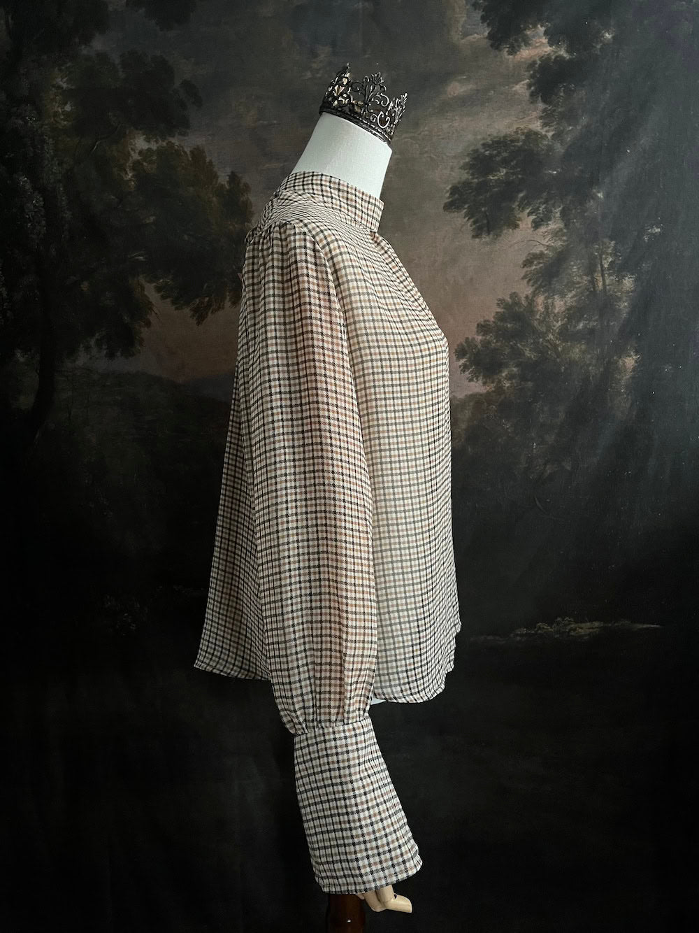 Mannequin wearing a vintage style historically inspired gingham check plaid blouse with bell sleeves and a mock neckline