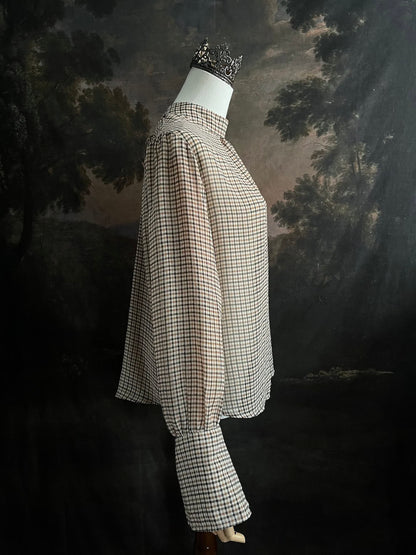 Mannequin wearing a vintage style historically inspired gingham check plaid blouse with bell sleeves and a mock neckline