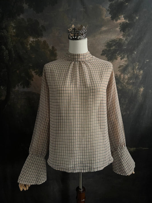 Mannequin wearing a vintage style historically inspired gingham check plaid blouse with bell sleeves and a mock neckline