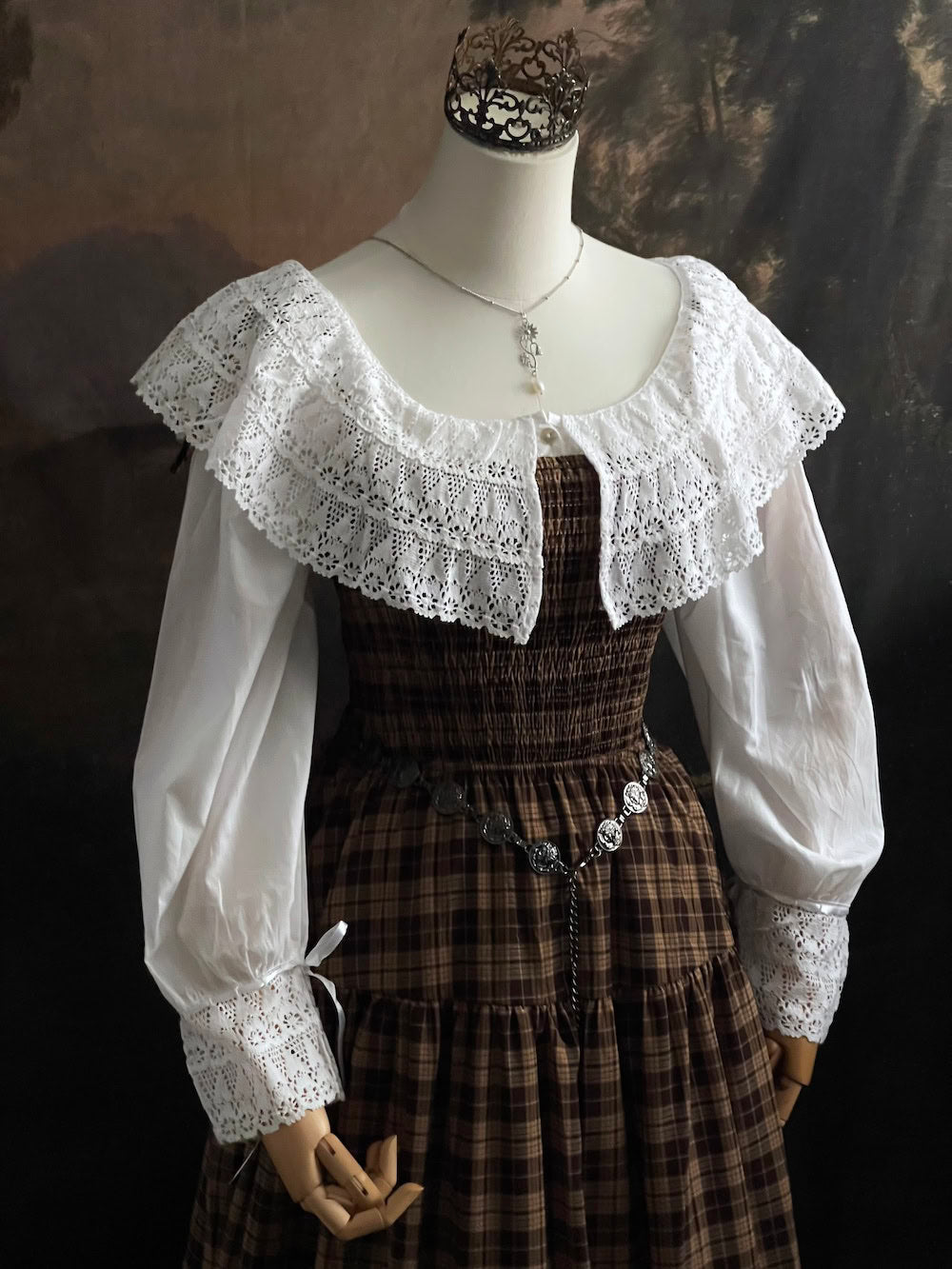 A styled outfit using a brown plaid maxi dress and a Baroque to Victorian era historically inspired white cotton chemise dress with large crochet lace collar and bishop sleeves