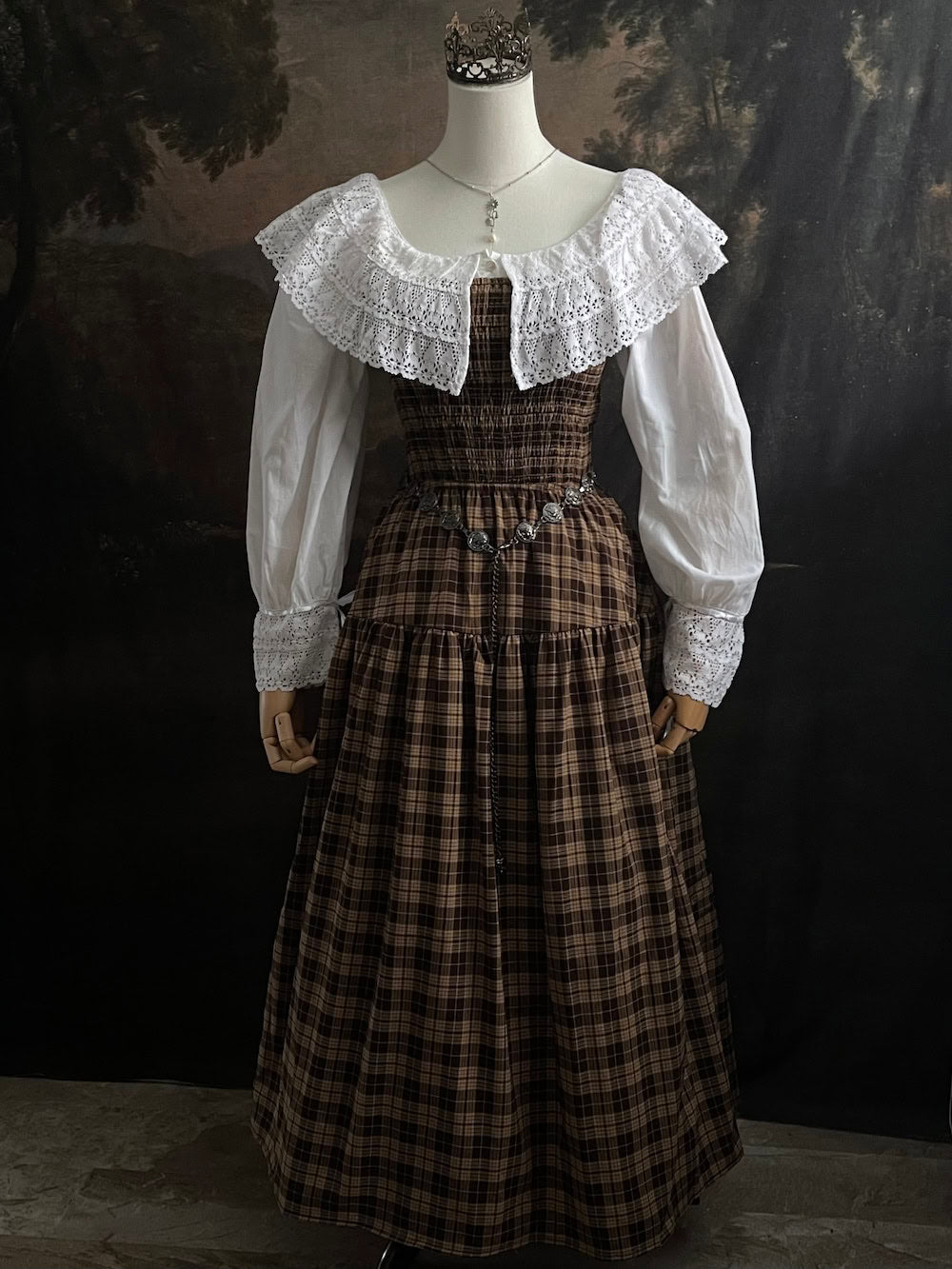 A styled outfit using a brown plaid maxi dress and a Baroque to Victorian era historically inspired white cotton chemise dress with large crochet lace collar and bishop sleeves