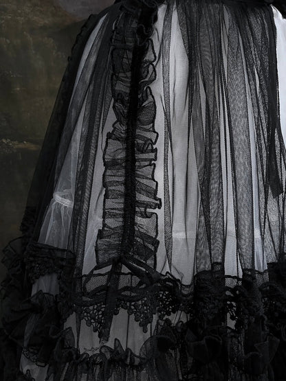 A versatile historically inspired overskirt and cape with lace trim and ruffle details in gothic black