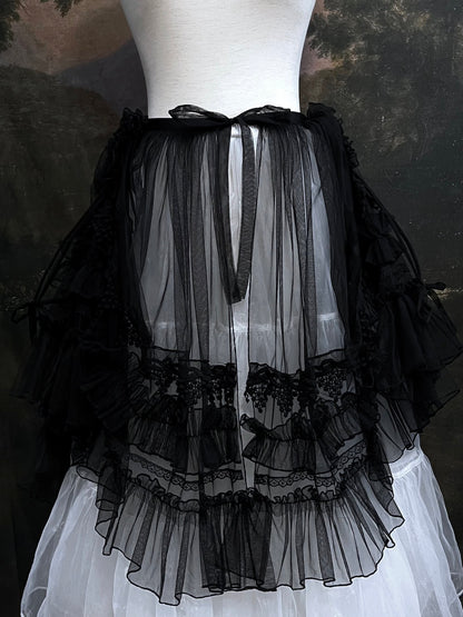 A versatile historically inspired overskirt and cape with lace trim and ruffle details in gothic black