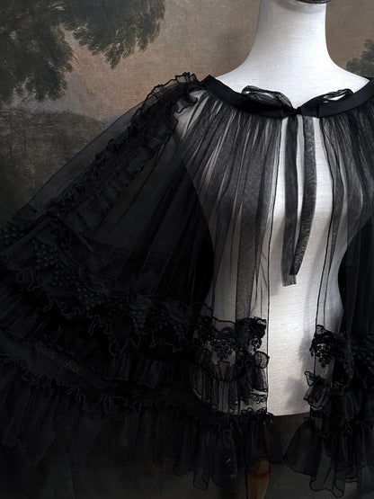 A versatile historically inspired overskirt and cape with lace trim and ruffle details in gothic black