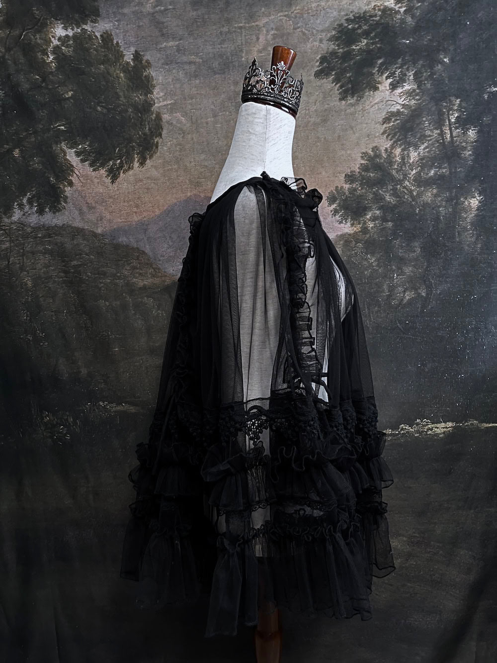 A versatile historically inspired overskirt and cape with lace trim and ruffle details in gothic black