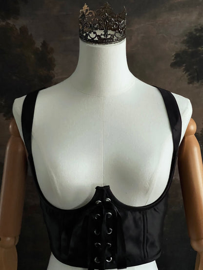 Black fantasy inspired underbust satin corset belt on a mannequin in front og an art history backdrop