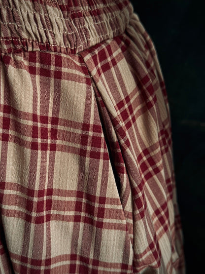 Close up of the pockets and burgundy and tan tartan fabric