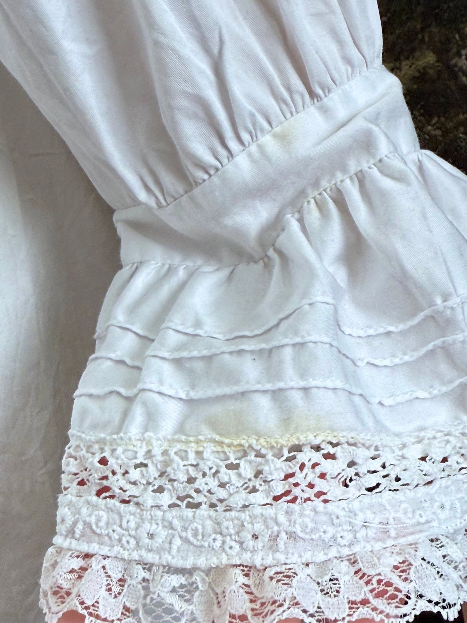 2-inch yellow stain on the sleeve of the dress.