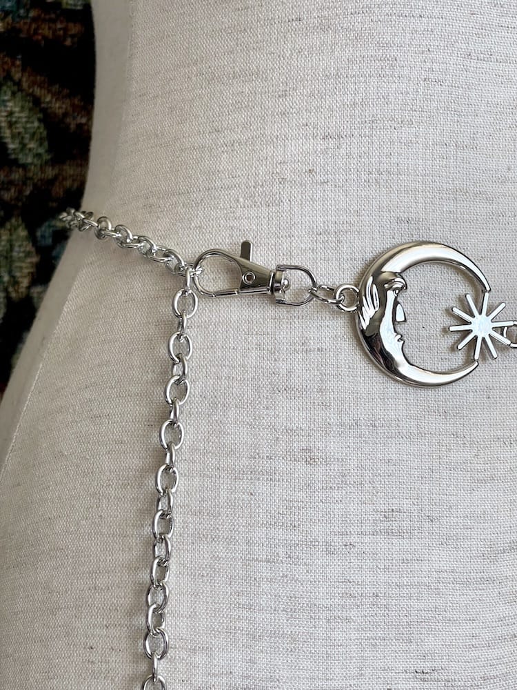 Detail image of a Historical Fantasy Inspired Celestial crescent Moon and Sun Belt in silver, pictured on a mannequin.