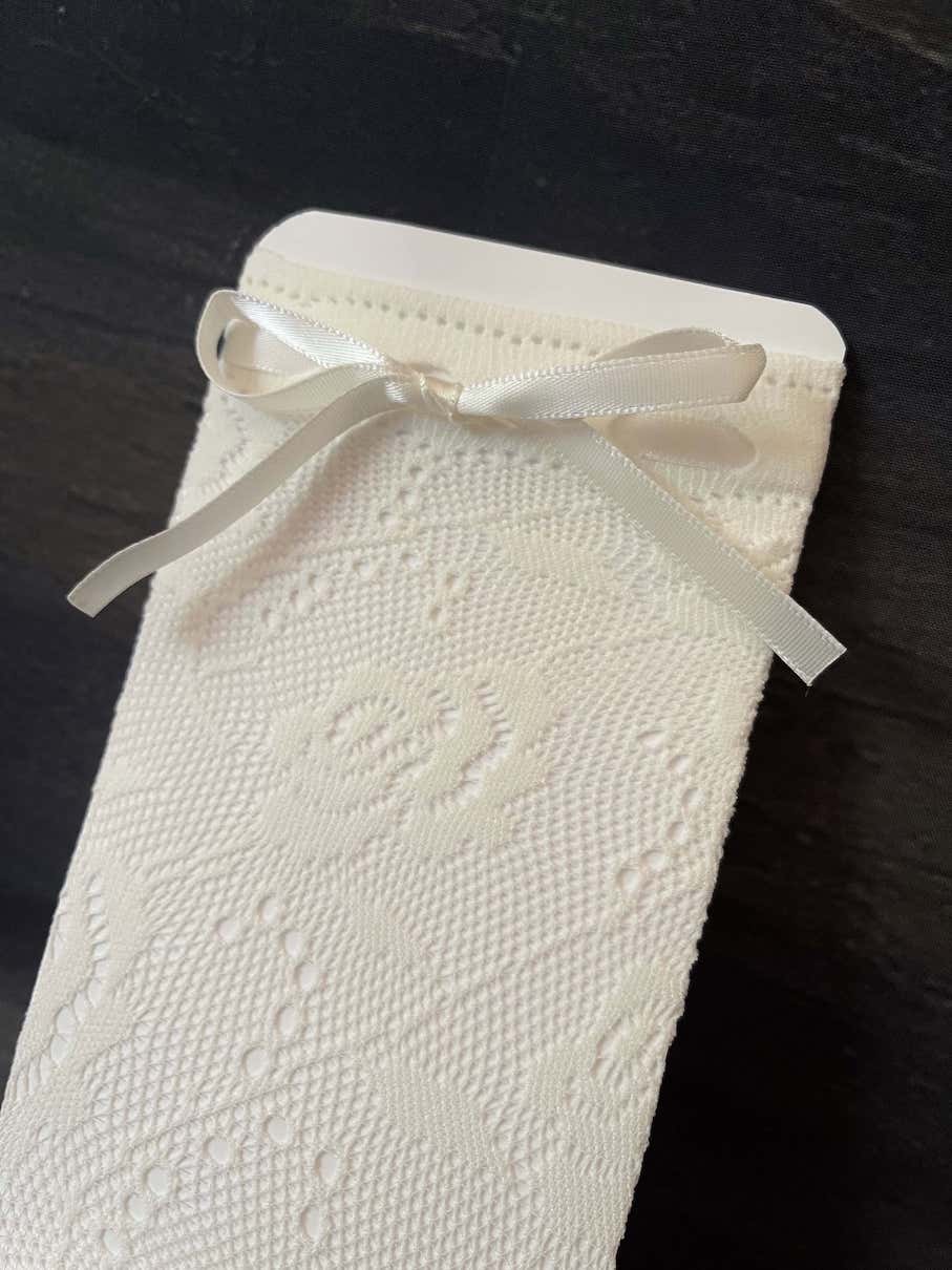 A Pair of historically inspired vintage style floral lace socks with satin ribbon bowtie. Edwardian, victorian, regency, rococo era.