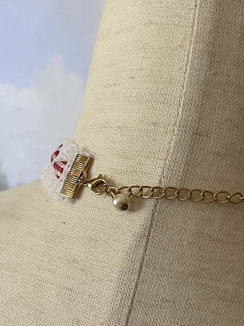 A Vintage style historically inspired cotton lace and gingham ribbon bow choker necklace in white and red.
