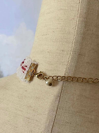 A Vintage style historically inspired cotton lace and gingham ribbon bow choker necklace in white and red.