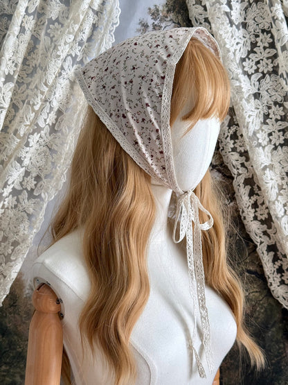 A Vintage inspired Cream & Pink Floral Print Babushka Triangle Headdress with lace trim on a mannequin head