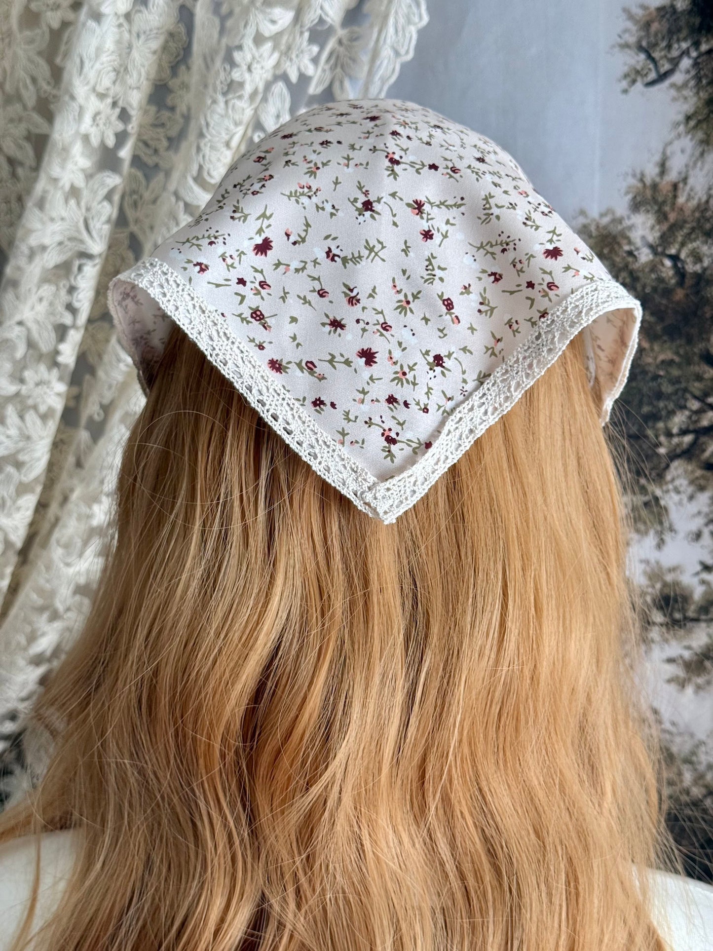 A Vintage inspired Cream & Pink Floral Print Babushka Triangle Headdress with lace trim on a mannequin head