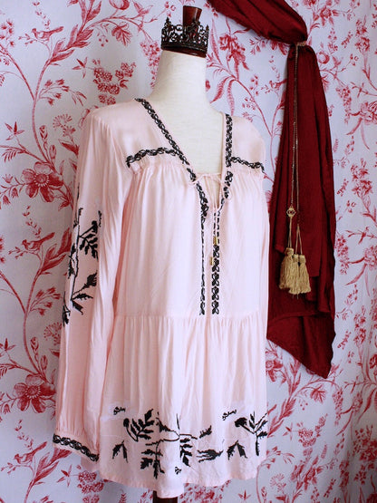 A Historically Inspired Pink and Black Floral Embroidered Medieval style folk tunic blouse with tie closure and bishop sleeves.