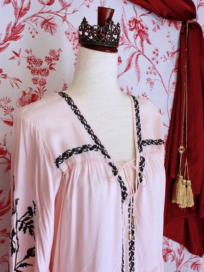 A Historically Inspired Pink and Black Floral Embroidered Medieval style folk tunic blouse with tie closure and bishop sleeves.