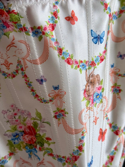 Detail of the fabric's print featuring flowers and a rabbit