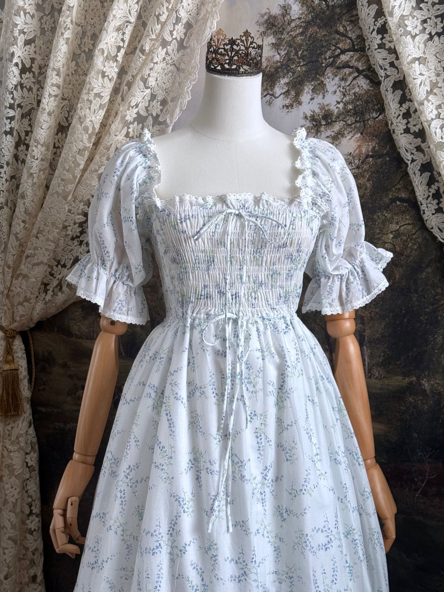 A Historically Inspired regency style puff sleeve White Floral Print Cotton Chemise maxi Dress with Shirred bodice, drawstring cinching laces, and lace trim.