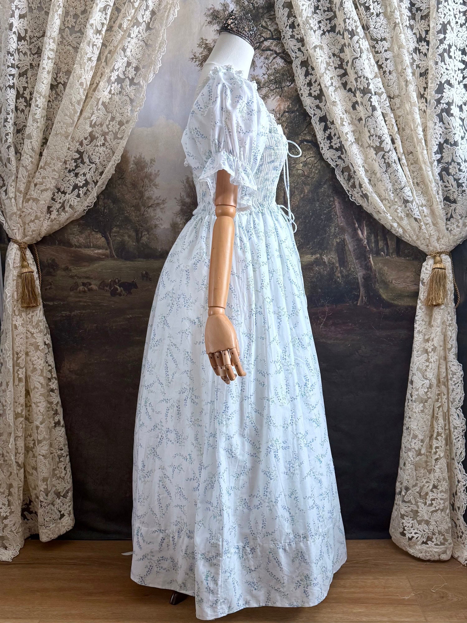 A Historically Inspired regency style puff sleeve White Floral Print Cotton Chemise maxi Dress with Shirred bodice, drawstring cinching laces, and lace trim.