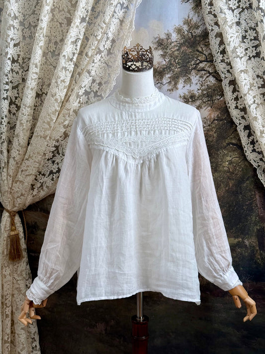White linen Victorian/ Edwardian-Inspired High Neck Pintuck Lace-Trimmed Blouse pictured on a mannequin.