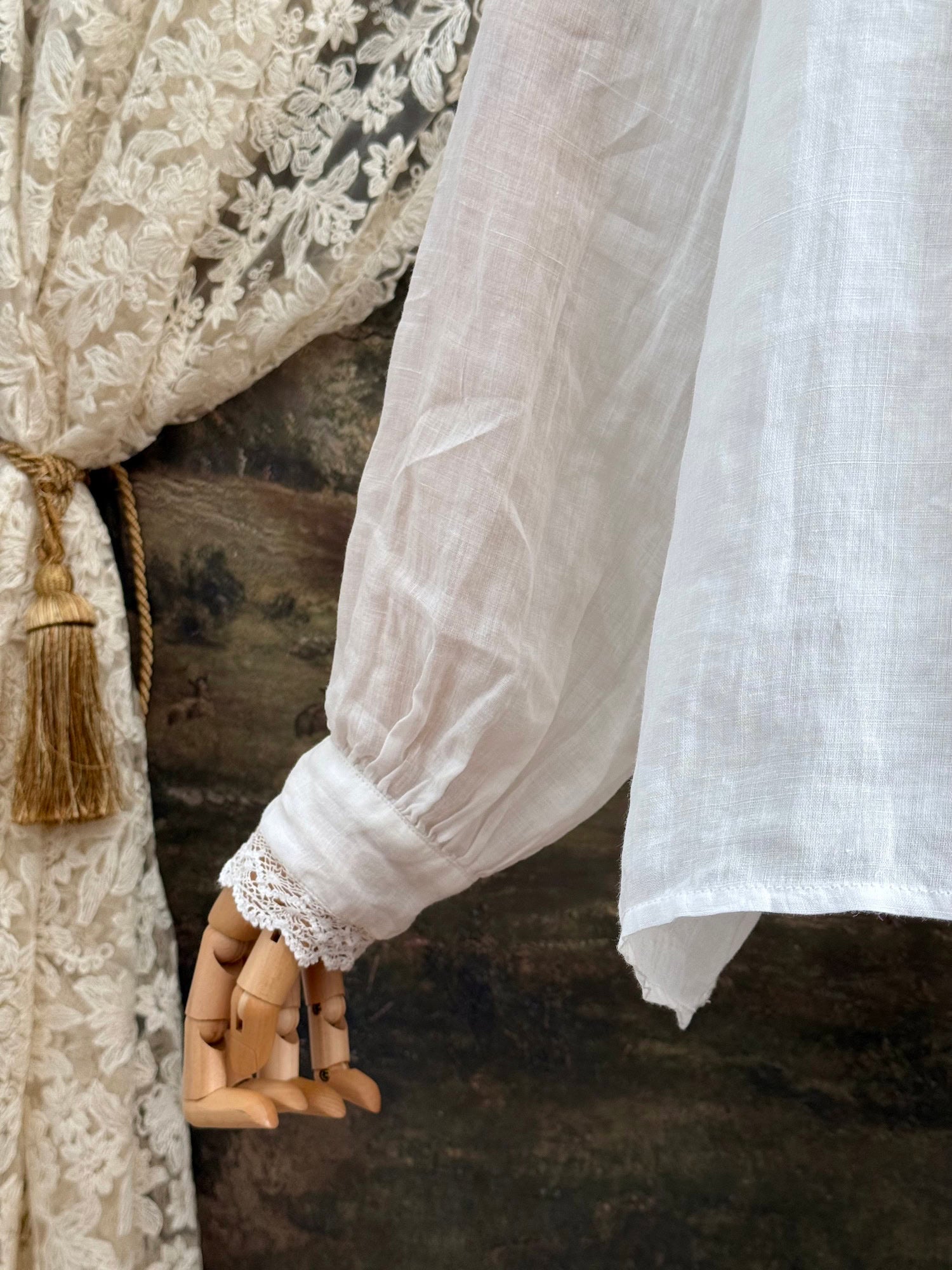 White linen Victorian/ Edwardian-Inspired High Neck Pintuck Lace-Trimmed Blouse pictured on a mannequin.