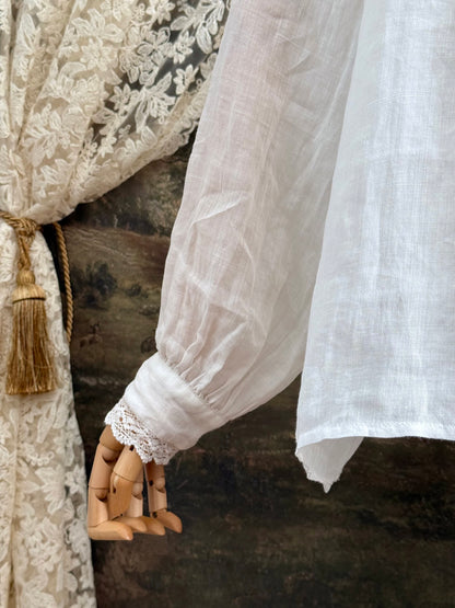 White linen Victorian/ Edwardian-Inspired High Neck Pintuck Lace-Trimmed Blouse pictured on a mannequin.