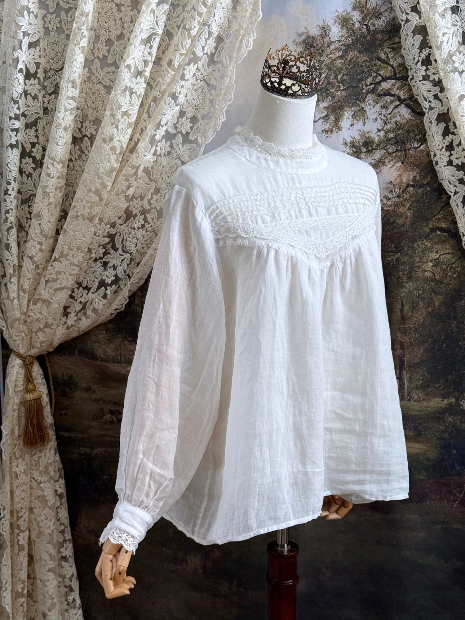 White linen Victorian/ Edwardian-Inspired High Neck Pintuck Lace-Trimmed Blouse pictured on a mannequin.