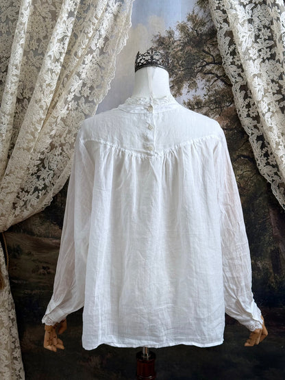 White linen Victorian/ Edwardian-Inspired High Neck Pintuck Lace-Trimmed Blouse pictured on a mannequin.