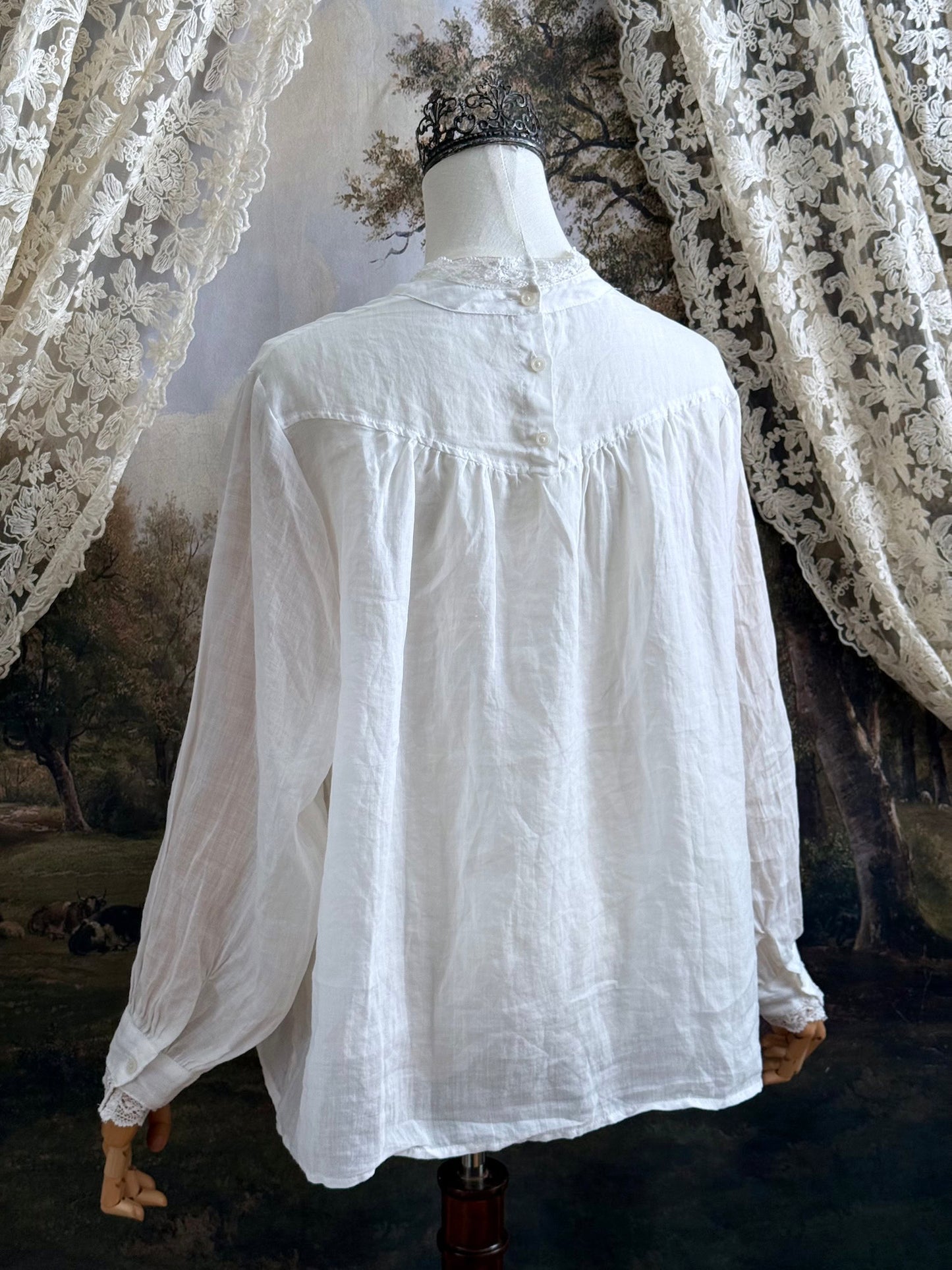 White linen Victorian/ Edwardian-Inspired High Neck Pintuck Lace-Trimmed Blouse pictured on a mannequin.