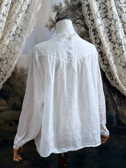 White linen Victorian/ Edwardian-Inspired High Neck Pintuck Lace-Trimmed Blouse pictured on a mannequin.