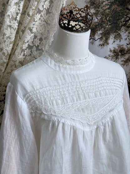 White linen Victorian/ Edwardian-Inspired High Neck Pintuck Lace-Trimmed Blouse pictured on a mannequin.