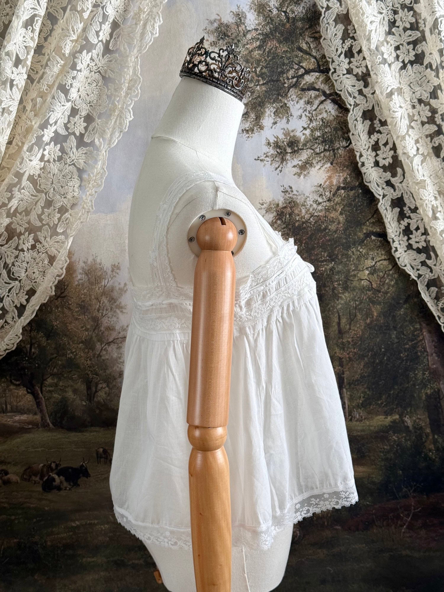 A victorian / edwardian inspired antique corset cover style tank top blouse made from white cotton and vintage design lace, pictured on a mannequin.