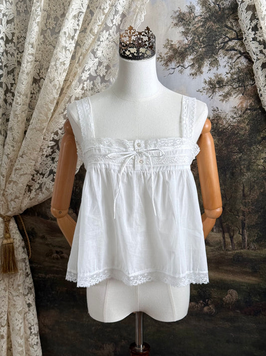 A victorian / edwardian inspired antique corset cover style tank top blouse made from white cotton and vintage design lace, pictured on a mannequin.