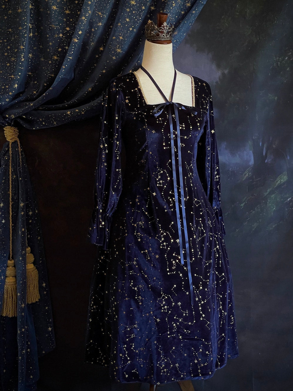 A Renaissance and Medieval Fantasy Inspired Celestial Star Velvet Bishop Sleeve Midi Dress with Satin Ribbon Neck Ties and a structured witchy whimsigoth silhouette.