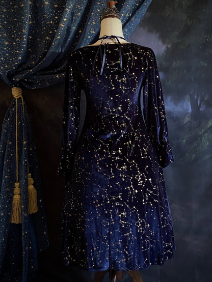 A Renaissance and Medieval Fantasy Inspired Celestial Star Velvet Bishop Sleeve Midi Dress with Satin Ribbon Neck Ties and a structured witchy whimsigoth silhouette.