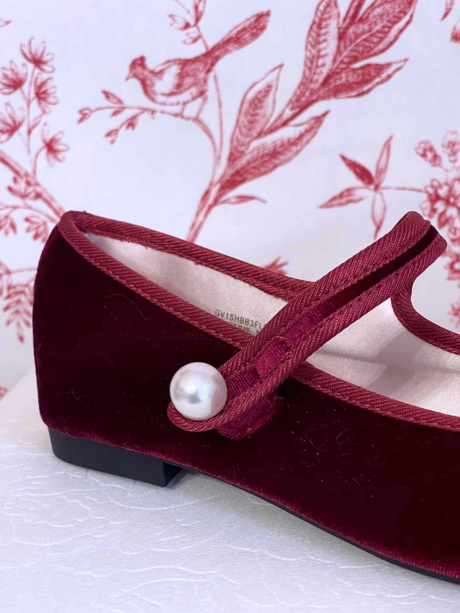 A pair of Historically Inspired Renaissance, Tudor, Baroque era Velvet Slipper Flats in Burgundy with pearl decorative button.