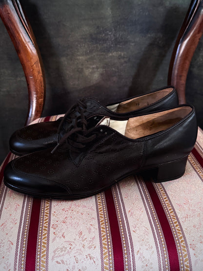 Dark brown leather vintage 1970s oxford derby shoes with heels and a textured pattern. Reminiscent of the 1940's. Pictured on a red and cream striped chair.