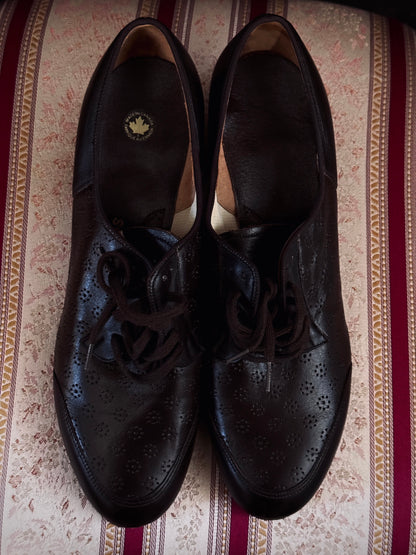 Dark brown leather vintage 1970s oxford derby shoes with heels and a textured pattern. Reminiscent of the 1940's. Pictured on a red and cream striped chair.