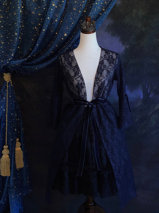 A Historically Inspired Witchy Whimsigoth Navy Blue Lace Flared Bell Sleeve Duster with a Bow-tied Velvet Ribbon Belt.